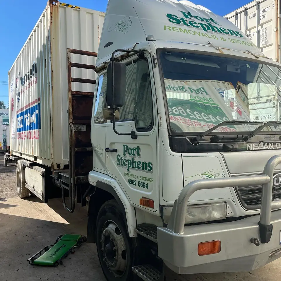 Fleet truck with box body parked at workshop
