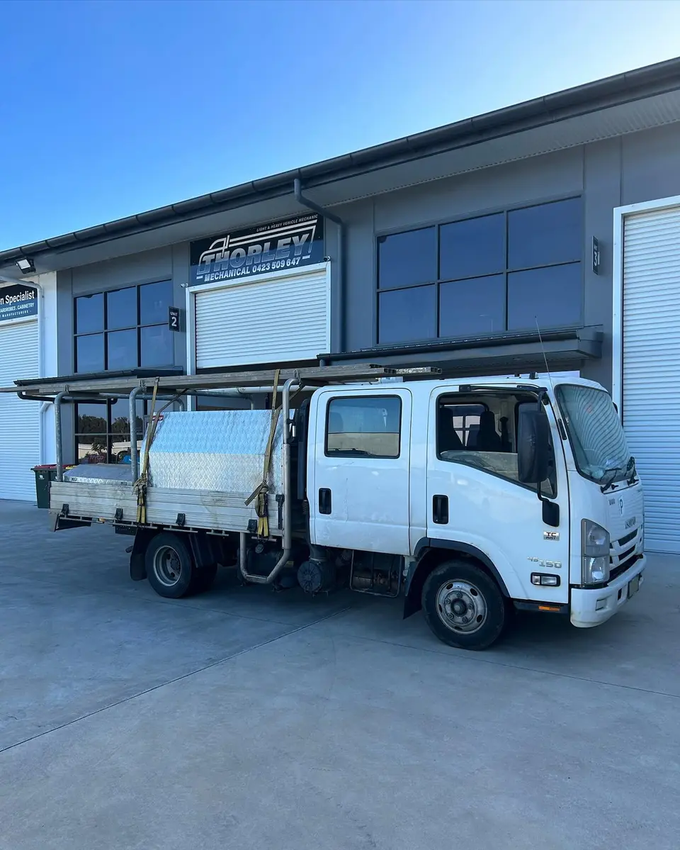 Commercial trucks parked outside the mechanical workshop