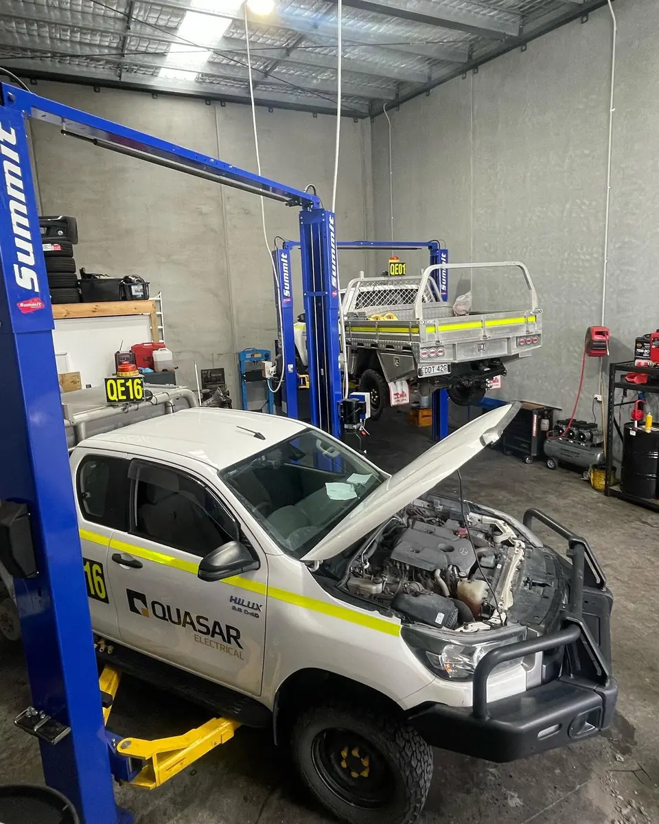 Commercial utility vehicle on a workshop hoist